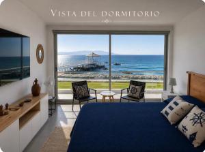 a bedroom with a bed and a view of the ocean at Ocean View Apartment Beach Pools Pier & Lift in Paracas