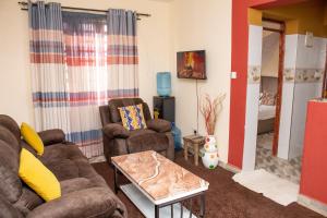a living room with two couches and a table at Amber Apartments G1 Kitengela in Athi River