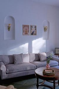 a living room with a couch and a table at Villa Eden 3BHK in Assagao