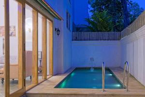 a swimming pool in the middle of a house at Villa Eden 3BHK in Assagao