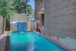 a swimming pool in the side of a building at TAJ VILLA Mahabaleshwar in Mahabaleshwar