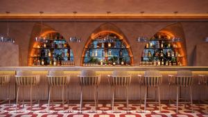 a row of chairs in a restaurant with a bar at Inna Resort & Spa in Puerto Morelos