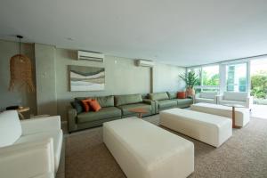 a living room with a couch and white furniture at Wave Suítes Hotel & Lounge bar in Maceió