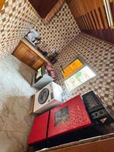 an overhead view of a kitchen with a stove and a microwave at Royal guest home in Bonamoussadi