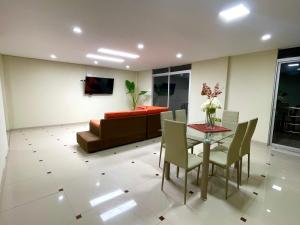 a living room with a table and a couch at La casa de Ferro in Piura