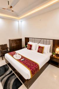 a bedroom with a large bed in a room at Premium Radhe Dham Hotel & Restaurant - Fully AC - Only 5 Min Drive to Prem Mandir, Newly Build in Vrindāvan