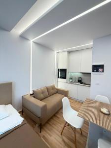 a living room with a couch and a table at Vellora Central Suite in Xanthi