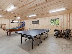 a ping pong room with a ping pong table in it at Hodges Hill Hideout w/ pool, spa, BBQ - Dog Friendly in Oakhurst