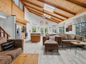 a living room with two couches and a kitchen at Hodges Hill Hideout w/ pool, spa, BBQ - Dog Friendly in Oakhurst +73 photos