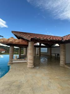 a pavilion with a roof on a patio at Finca La Yeye in Puentetierra