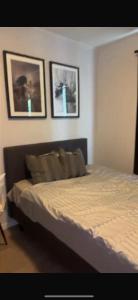 a bedroom with a bed with two pictures on the wall at Studio in Fjellhammar
