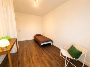 a small room with a bed and a chair at Modern 2 BR apartment in Centre in Sint-Niklaas