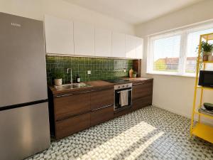 a kitchen with a sink and a stove top oven at Modern 2 BR apartment in Centre in Sint-Niklaas