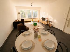 a living room with a white table and chairs at Modern 2 BR apartment in Centre in Sint-Niklaas