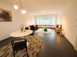 a living room with a table and a couch at Modern 2 BR apartment in Centre in Sint-Niklaas