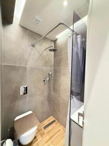 a bathroom with a shower with a toilet at Vellora Central Suite in Xanthi
