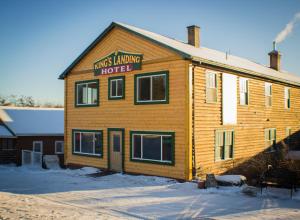 a wooden building with a sign that reads kings living hotel at Kings Landing in Homer