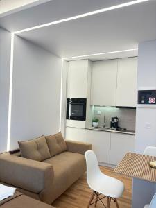 a living room with a couch and a kitchen at Vellora Central Suite in Xanthi +1 photo