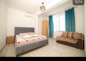 a bedroom with a bed and a couch at Cozy Apartments in Ulcinj