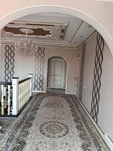 an ornate hallway with a chandelier and a staircase at BoNa Guest in Bishkek