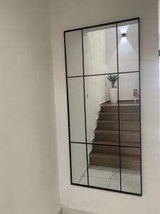 a mirror on a wall in a room with stairs at Cozy Apartments in Ulcinj