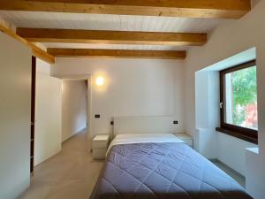 a bedroom with a bed in a room with a window at Piazza Maggiore Charming Apartament in Santa Maria Maggiore +6 photos