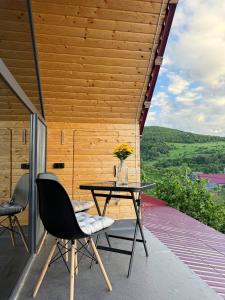 a patio with a table and chairs on a deck at Debed View in Debed