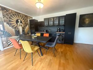 a kitchen with a dining room table and chairs at Cosy Carré in Sélestat