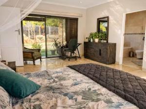 a bedroom with a large bed and a bathroom at Salt and stone in Cape Town +37 photos
