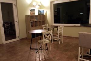 a dining room with two tables and white chairs at Il Rifugio in Franciacorta in Erbusco +9 photos