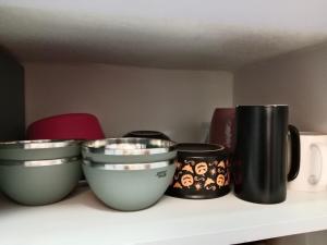 a shelf with four bowls on top at Stupas, Temples and Coffee 2BR Flat in Kathmandu in Kathmandu +2 photos
