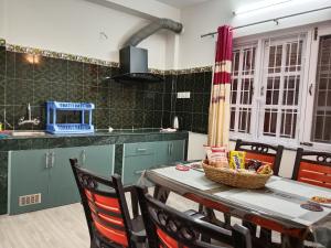 a kitchen with a table with a basket on it at Stupas, Temples and Coffee 2BR Flat in Kathmandu in Kathmandu