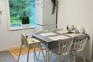 a kitchen with a table with chairs and a refrigerator at Garden View vacation home in Granna in Gränna