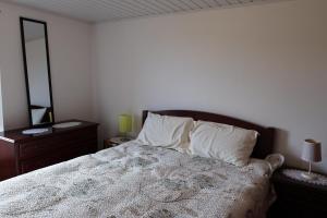 a bedroom with a large bed with two mirrors at Casa das Brisas Matinais in Conceição