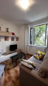 a living room with a couch and a window at Villa sul mare di Cupra in Cupra Marittima