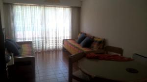 a living room with a couch and a window at Arco Iris in Miramar