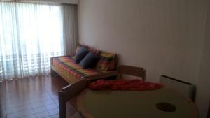 a living room with a couch and a table at Arco Iris in Miramar