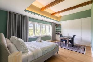 a bedroom with a bed and a table and a desk at Greycliff Mohonk Preserve Getaway in New Paltz