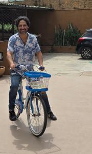 a man riding a bike with a basket at Casa Centro Historico Hostel in Oaxaca City