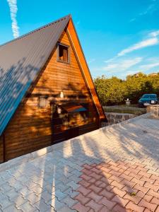 a large wooden barn with a brick roof at Mira Bungalov in Trabzon