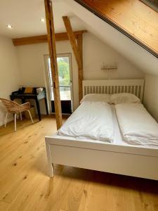 a large bed in a room with a piano at Kaiserblick Lodge Oberaudorf in Oberaudorf