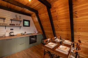 a kitchen with a table and chairs in a cabin at Durmitor forest lodge in Žabljak