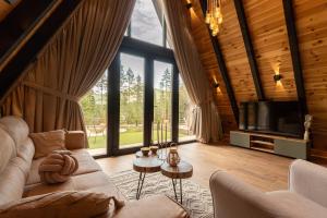 a living room with a couch and a tv at Durmitor forest lodge in Žabljak