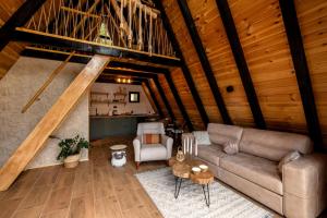 a living room with a couch and a table at Durmitor forest lodge in Žabljak