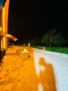 a shadow of a person walking by a wall at Mira Bungalov in Trabzon