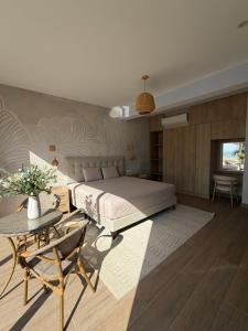 a bedroom with a large bed and a table at Casa Marena Punta Sal in La Bocana