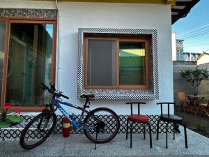 a bike is parked next to a house at Hanok Stay Ohneul in Gyeongju
