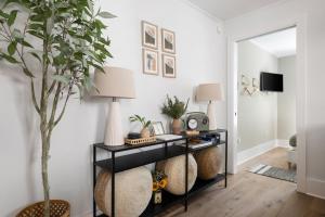a living room with a black shelf with a plant at Downtown CHS King Beds Convert to Singles in Charleston