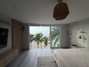 a bedroom with a bed and a view of the ocean at Casa Marena Punta Sal in La Bocana +48 photos