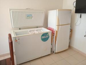 a kitchen with a refrigerator and a washer and dryer at Coastal Apartment in Monte Caseros